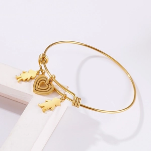 Adjustable gold titanium heart charm bracelet with character pendants on a white stand