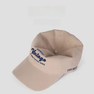 Detailed embroidery on light khaki soft top baseball cap with navy blue vintage lettering