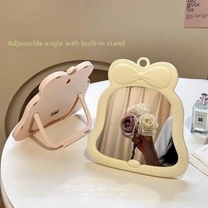 Bowtie desktop makeup mirror in cream yellow with adjustable back stand detail