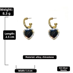 Detail view of heart earrings with black stone and rhinestones on 925 silver needles