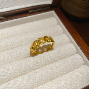 Macro shot of gold-plated ancient coin style ring in a luxury wooden gift jewelry box