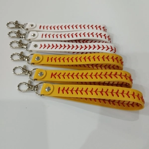 Detail view of baseball and softball pattern leather wristlet keychains with red stitching