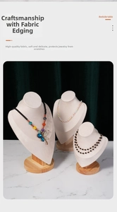 Three tiered beige velvet necklace display busts with natural wooden bases for jewelry staging