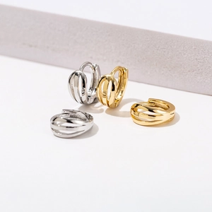 Detail of 18K gold and silver plated triple-layer geometric huggie hoop earrings