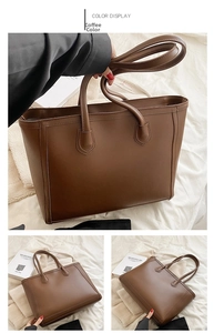 Detail view of large coffee brown PU leather tote bag with vertical stitching and dual handles