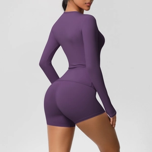 Detail view of purple long sleeve yoga top and high waist shorts with sleek fit