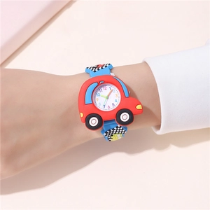 Close-up of red car-shaped watch case with colorful numbers and a blue strap