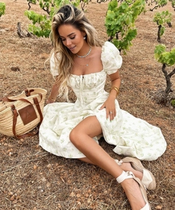 Close-up of floral print summer dress with puff sleeves and lace-up square neckline