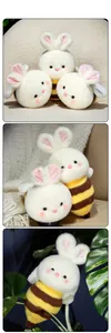 Close-up of soft bee-bunny plush toy with striped body and fluffy white rabbit ears