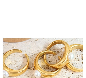 Close-up of a gold-plated stainless steel chunky ring with white pearl inlays