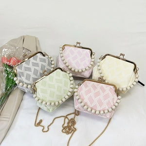 Detail showing five pastel seashell bags with pearl handles and metal chain straps