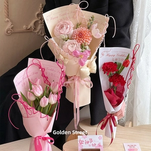 Close-up of three mini bouquets with pink tulips and red carnations for DIY flower gifting