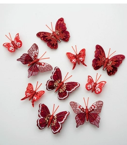 Detail of red fabric butterflies with gold glitter texture and metal clips for Christmas decor