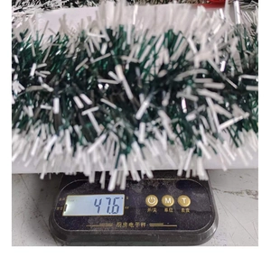 Close-up of green and white Christmas garland on electronic scale weighing 47.6g