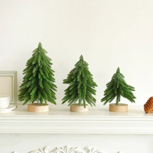 Miniature flocked Christmas trees set with natural wooden bases for festive holiday decor
