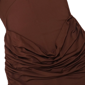 Detailed view of the ruched side seam and textured brown fabric of the mini dress