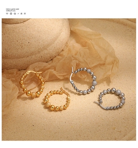 Detail of gold and silver beaded hoop earrings with matte and polished finishes