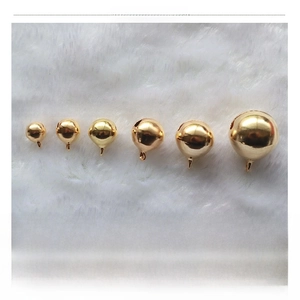 Comparison of golden round metal bells in sizes 8mm to 20mm on white plush background