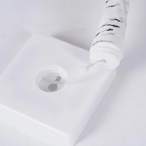 Close-up of the white square base and birch texture trunk of the LED decorative tree lamp