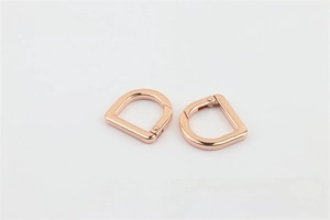 Macro shot of rose gold D-ring spring clasps for handbag straps and leathercraft hardware