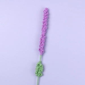 Handmade knitted purple lavender flower stalk with green leaves on purple background
