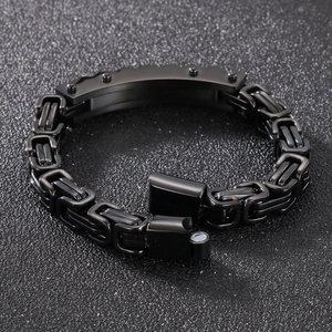 Detail of black titanium steel chain bracelet with curved plate and magnetic clasp
