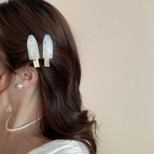 Detail of acrylic ice cream hair clips with colorful rhinestones on model
