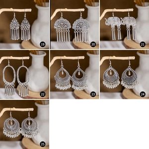 Detailed set of bohemian retro silver earrings with ethnic tassels and floral patterns