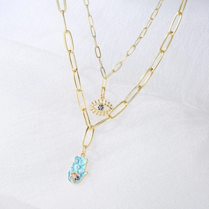 18K gold plated layered paperclip necklace with Hamsa hand and Evil Eye charms