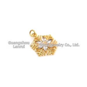 Macro detail of 18k gold plated snowflake pendant with sparkling white cubic zirconia