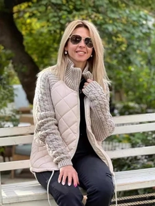 Women's quilted zip-up jacket in beige featuring knit sleeves and a stand collar