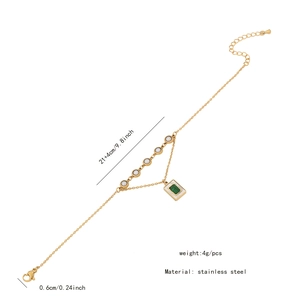 Detailed close-up of golden stainless steel anklet with green turquoise and white pearl