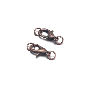 Close-up of vintage bronze lobster clasps and jump rings for DIY jewelry making