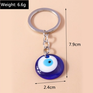 Macro detail showing Evil Eye keychain dimensions with circular blue glass pendant