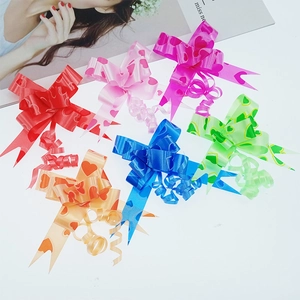 Macro detail of multi-colored pull flower bows with gold edges and heart pattern prints