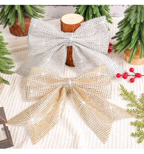 Close-up of gold and silver sparkling Christmas bows with rhinestones on a festive background