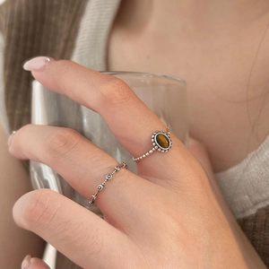 Macro detail of S925 sterling silver tiger eye ring featuring vintage beaded textures