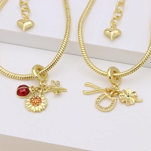 18k gold-plated snake chain bracelet with ladybug and sunflower charms on steps