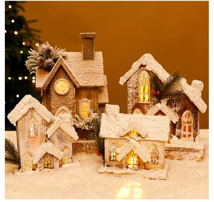 Close-up of lighted Christmas wooden snow house with pine cones and warm LED lights