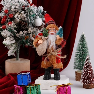 Detail of plush Santa Claus figure with red plaid coat and gift bag on snowy festive background