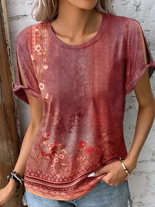 Detail of bohemian floral print T-shirt with cutout shoulder design on vintage red fabric