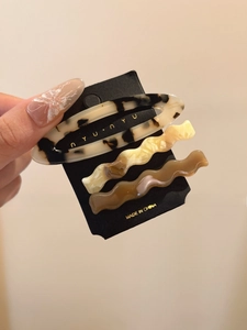 Close-up of tortoise shell pattern and wave resin hair clips set for women