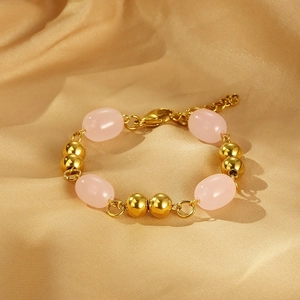 Chic pink resin and gold bead bracelet on silk, featuring lobster clasp and extension chain