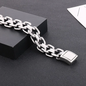 Detail shot of men's interlocking curb chain bracelet with magnetic clasp in silver finish