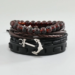 Detailed close-up of multilayer leather bracelets with wood beads and silver anchor charm