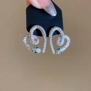 Sparkling S925 silver snake-shaped heart earrings with white zircon and green stone eyes