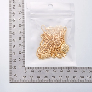 Detailed view of golden necklace chain length measured with a metric steel ruler
