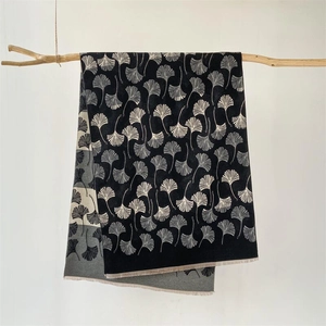 Elegant black cashmere-like scarf with white ginkgo leaf pattern and fringe edges
