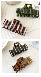 Detail of checkered and striped large hair claws with heart cutout in various colors