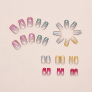 Macro detail of multi-color cat-eye gradient press-on nails with shimmering metallic finish